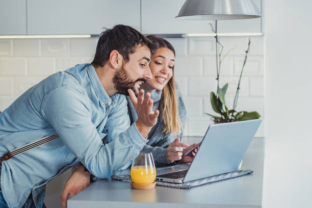 istock Young couple at home using laptop 1199520323