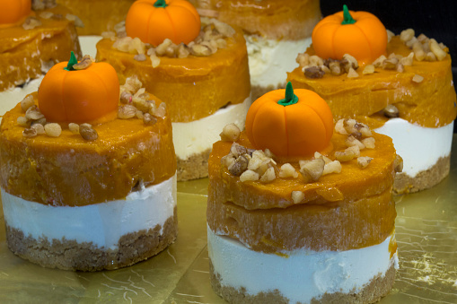 Close-up view of delicious pumpkin sweets for Halloween concept. Patisserie, Halloween, pumpkin, cake concepts. Horizontal shooting.