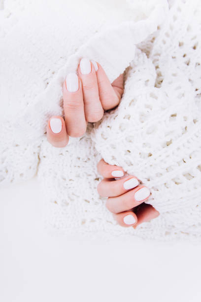 istock Stylish trendy white manicure. Tender female hands. 1199522930