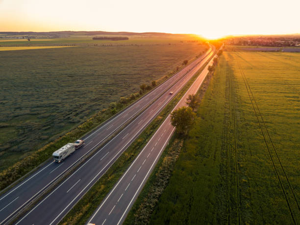 istock Cars on the road at sunset 1199528712