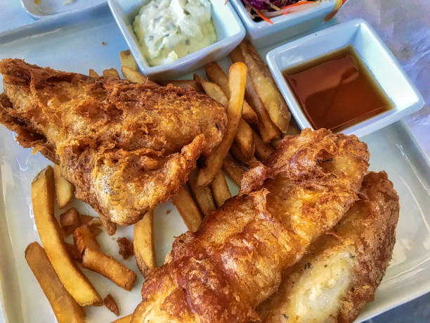 istock Fish and chips with salad and sauce 1199532219