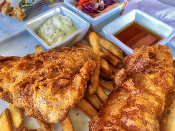 istock Fish and chips with salad and sauce 1199532744