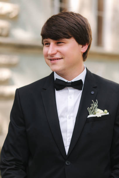 istock Handsome groom in black suit going down the stairs 1199533445