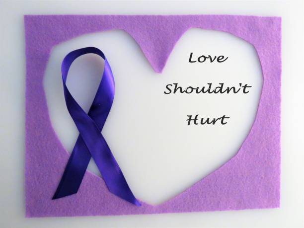 Purple ribbon on hearts; "Love Shouldn't Hurt"; abuse, domestic violence Purple ribbon on hearts; "Love Shouldn't Hurt"; abuse, domestic violence Christine Kohler stock pictures, royalty-free photos & images