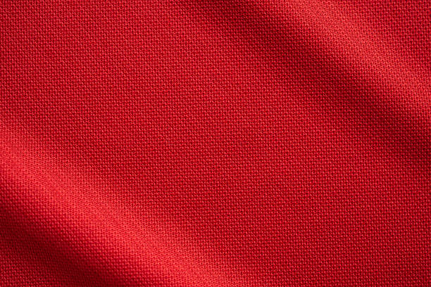 red sports clothing fabric football jersey texture close up - red cloth imagens e fotografias de stock