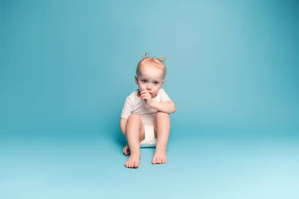 istock little girl sucks a finger, looking down 1199536442