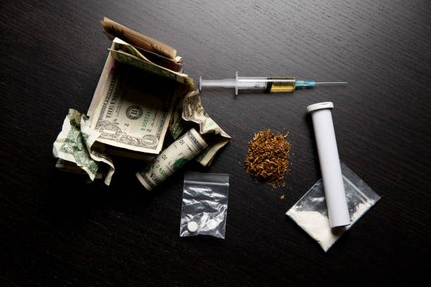 different drugs and crumpled dollars on the table different drugs and crumpled dollars on the table symbolize the wrong way of life snorting stock pictures, royalty-free photos & images