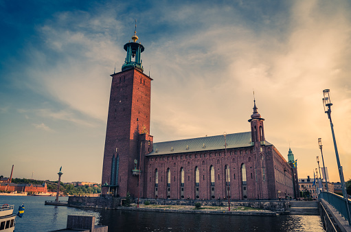 Stockholm City Hall (Stadshuset) tower building of Municipal Council and venue of Nobel Prize on Kungsholmen Island in old town near Lake Malaren with blue sky and white clouds background, Sweden