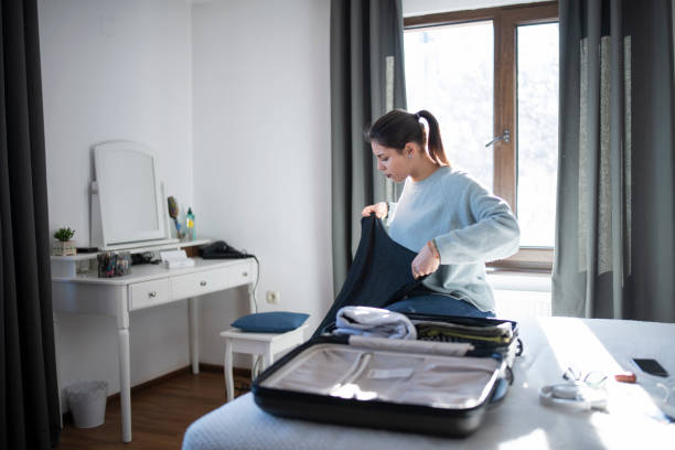 istock Woman Prepares luggage 1199536848