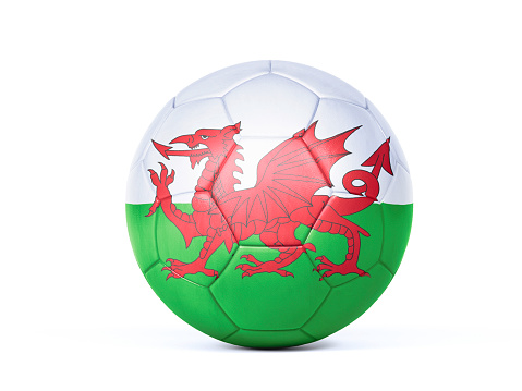 Welsh flag on a soccer ball over soccer field. Easy to crop for all your social media and design need.