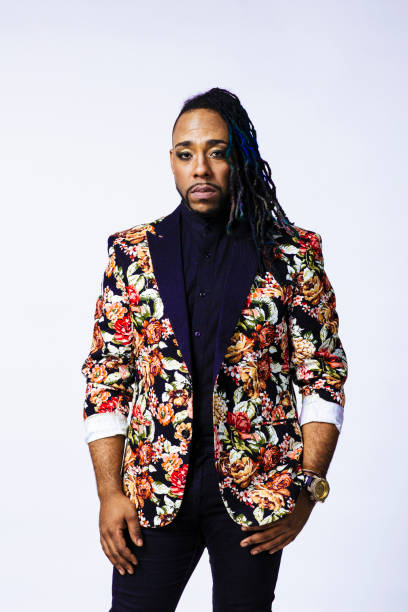 istock Studio portrait of a man wearing a flower patterned suit and dreadlocks 1199537040