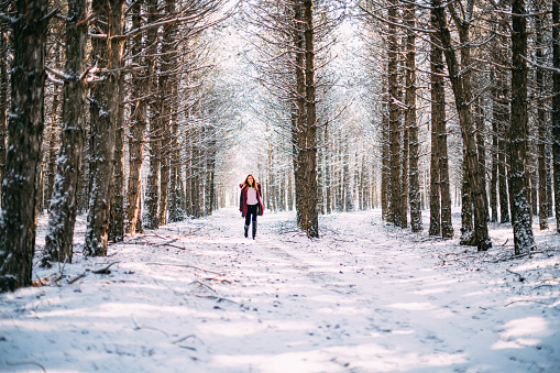 Blond Woman Hikers in Snowy Forest