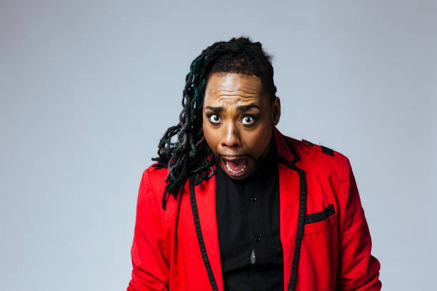 istock Studio portrait of a man wearing a red jacket suit and dreadlocks 1199537353