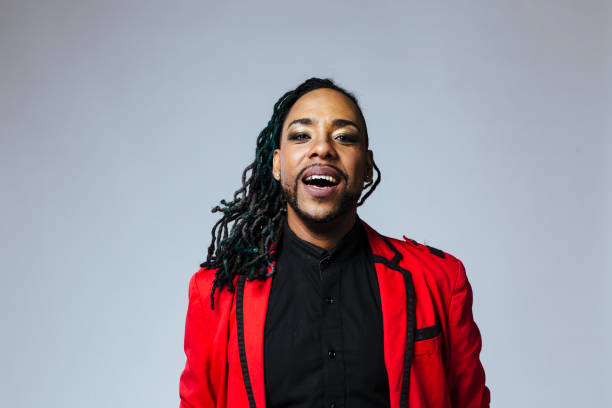 istock Studio portrait of a man wearing a red jacket suit and dreadlocks 1199537364
