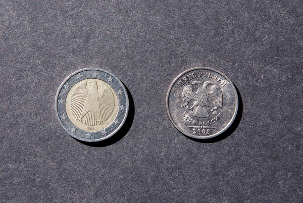istock Two coins euro and ruble tails up 1199538160