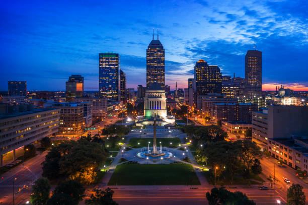 Indianapolis Skyline and Park Aerial at Dusk Downtown Indianapolis skyline aerial at dusk with Obelisk Square and the Indiana World War Memorial in the foreground. indianapolis photos stock pictures, royalty-free photos & images