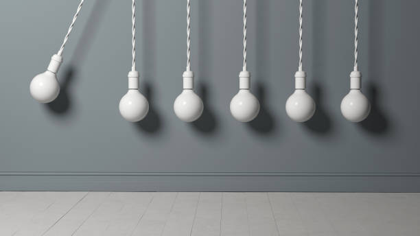 istock light bulb as pendulum is hitting other lightbulbs like in a newton cradle 1199544974