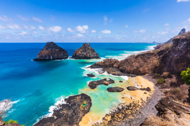 View of Morro dos Dois Irmãos and Baia dos Porcos in Fernando de Noronha, Brazil Baia dos Porcos is one of the most beautiful beaches in Fernando de Noronha and is home to several natural pools. two brothers mountain stock pictures, royalty-free photos & images