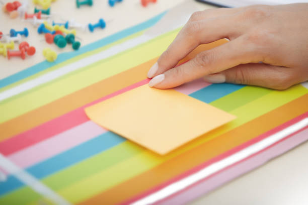 istock Businesswoman sticking adhesive note with empty space 1199549063