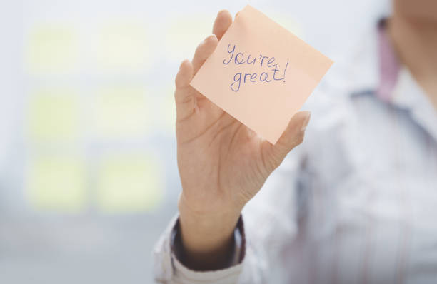 Cropped shot of a mature businesswoman brainstorming with notes on a glass wall