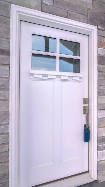 istock Vertical White wooden front door with sash windows 1199550094