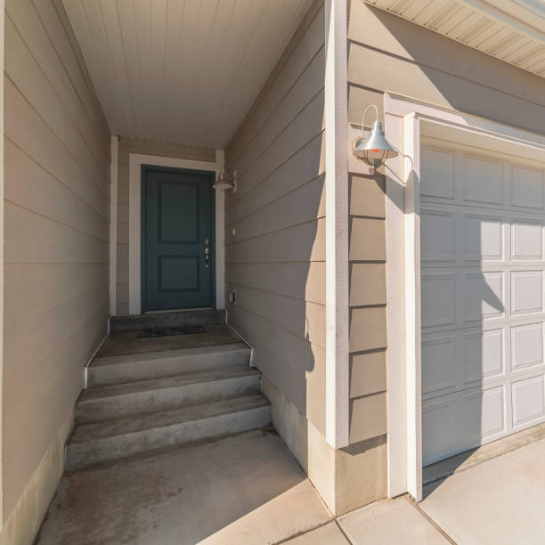 istock Square frame White garage door with recessed covered entrance 1199550130