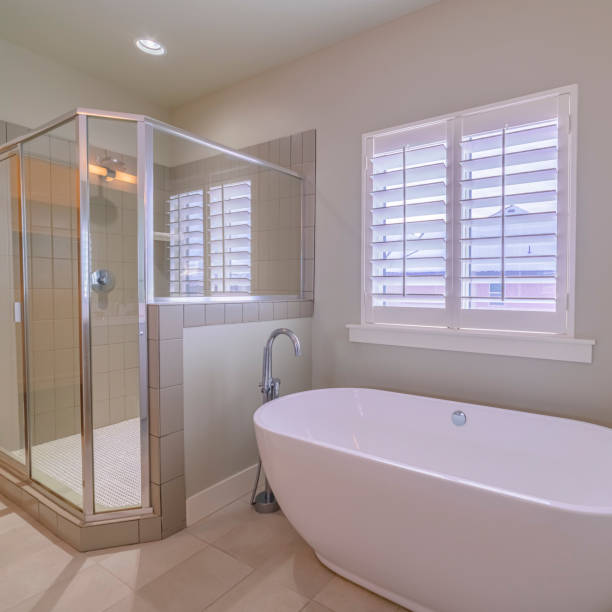 istock Square Modern luxury bathroom with boat-shaped tub bright interior 1199550147