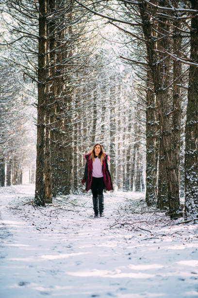 istock Blond Woman Hikers in Snowy Forest 1199550920