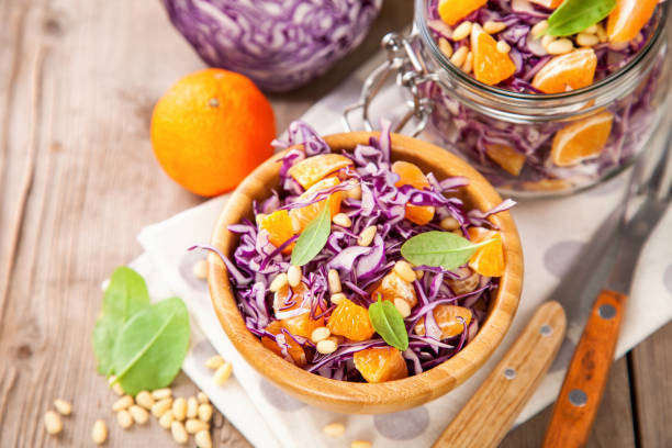 istock Red cabbage tangerines and pine nuts salad. Selective focus. Copy space. 1199553292