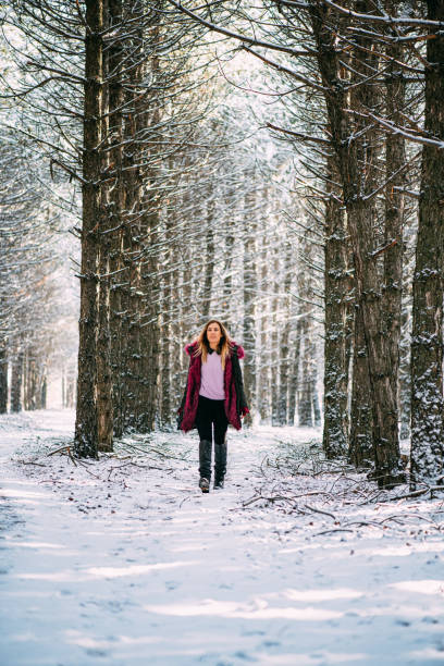 istock Blond Woman Hikers in Snowy Forest 1199554329