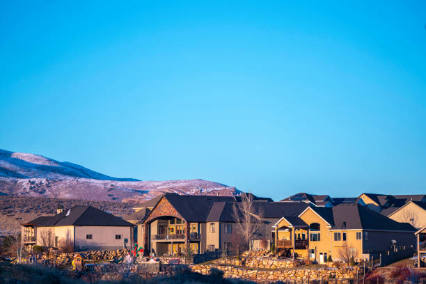 istock Distant houses against snow covered hills day light 1199554889