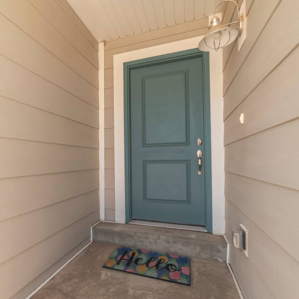 istock Square frame Blue wooden front door with Hello welcome mat 1199555153