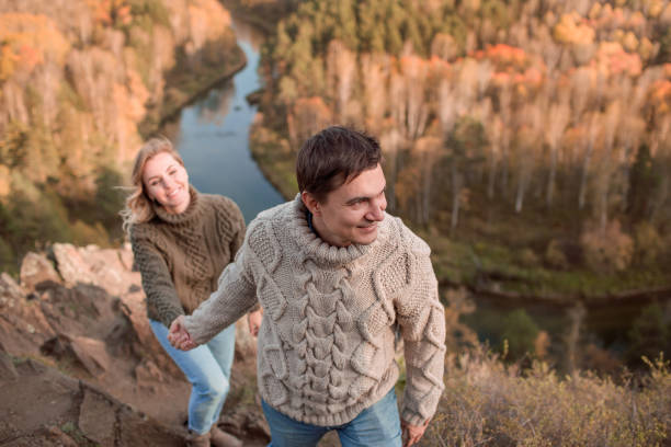 istock Beautiful Romantic Couple Walk On The Mountain Peak Holding Hands 1199555512