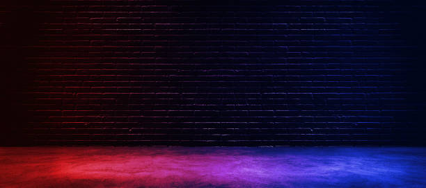 istock Studio dark room with lighting effect red and blue on black brick wall gradient background for interior decoration. 1199556359