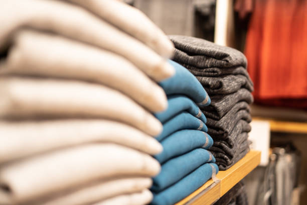 istock close up row of stack cloth on shelf  in shop. 1199564065