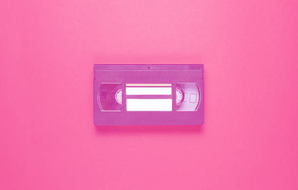 istock Pop culture retro attributes 80s, video cassette on red background. Top view 1199568430