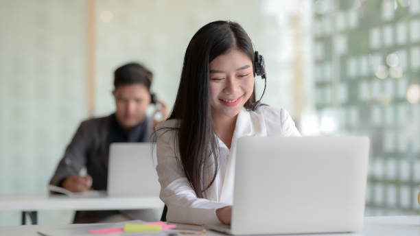 istock Close up view of customer service  talking on headset  in call centre operation room 1199568802