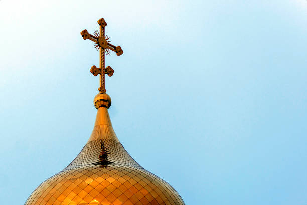 Dome of golden-colored chapel against blue sky. Concept