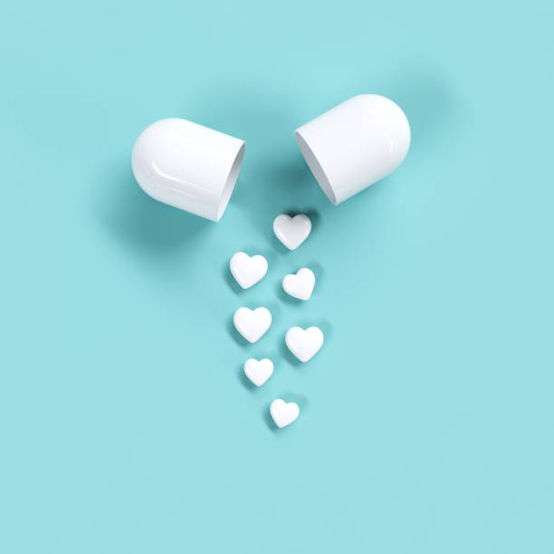 istock White Pills heart concept idea on green color background. Minimal valentine ideas. 3D Render. 1199568978