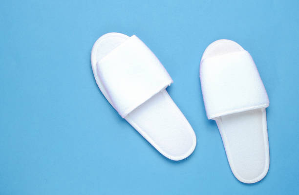 istock White hotel slippers on blue background. Top view. Minimalism 1199569896