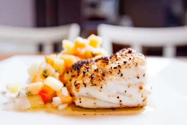 Grilled grouper dinner topped with mango salsa