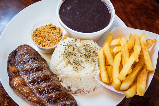 Typical Brazilian style lunch with steak, french fries, rice and beans