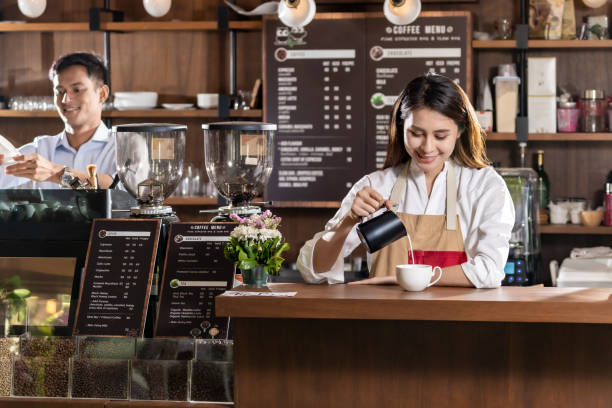 istock Female barista making coffee 1199572052