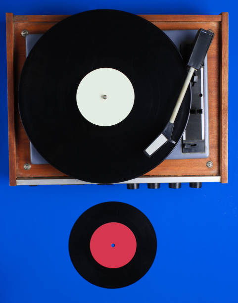 istock Retro vinyl record player, lp record on blue background. Top view. Retro style. Flat lay. 1199572316