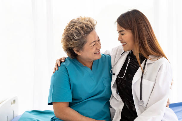 istock doctor hugging elderly patient 1199572397