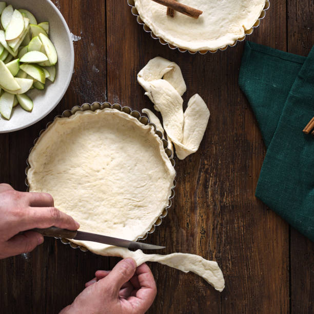 istock Man preparation homemade apple pie top view 1199579438