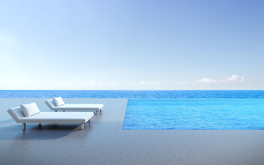 View of day bed on terrace and infinity pool, sea view background,Blue pool. 3D rendering