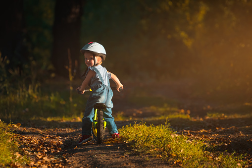 little girl riding a run bike