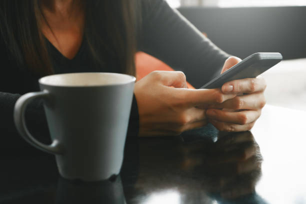 istock Online with Smartphone. Woman and coffee cup. 1199584149