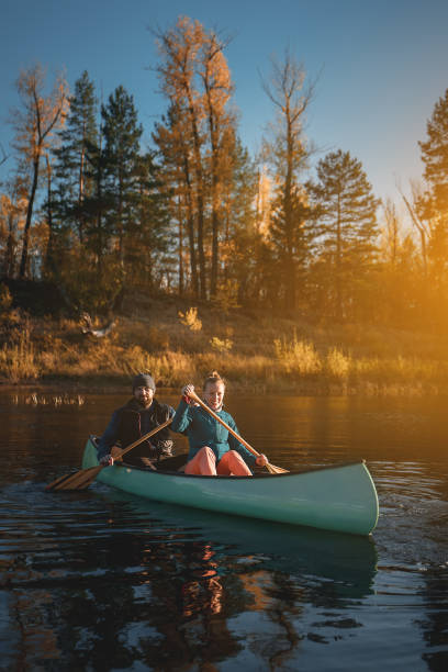 istock Happy couple in canoe at sunset. 1199584152